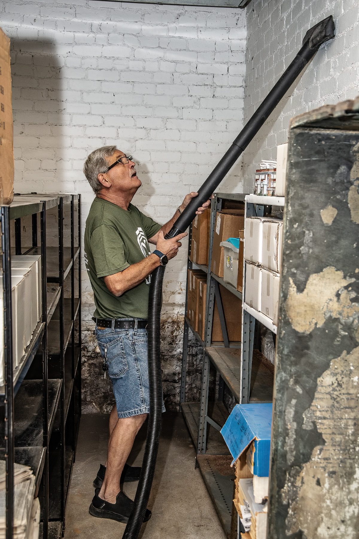 A volunteer works on archival shelving inside the Cass County Museum