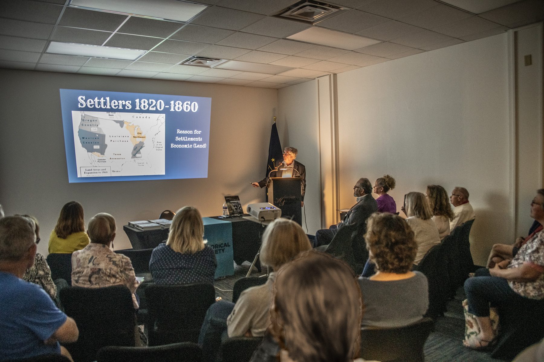 An audience watches a history presentation at the Cass County Museum