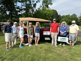 Board members and guests gathered around the ReVere automobile on the museum lawn