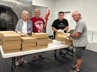 Volunteers packing archival boxes at the Cass County Museum